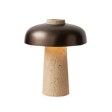 Table lamp with brown metallic shade and beige base on a white background