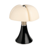 Table lamp with a black base and white shade on a white background