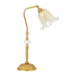 Gold table lamp with a white glass shade on a white background